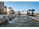 A serene water feature is showcased with palm trees lining the pool area under a clear sunny sky at 331 Cleveland St # 402, Clearwater, FL 33755