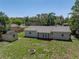 Aerial view of the home, firepit, shed, backyard and back porch at 34477 Poinsettia Pl, Dade City, FL 33523