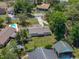 Overhead view showcases property, outdoor features, and surrounding neighborhood with lush landscaping at 34477 Poinsettia Pl, Dade City, FL 33523
