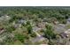 Aerial view of home nestled among trees in the neighborhood at 34477 Poinsettia Pl, Dade City, FL 33523
