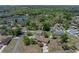Panoramic aerial shot of a home nestled among trees, complemented by a nearby lake, showcasing a serene setting at 34477 Poinsettia Pl, Dade City, FL 33523