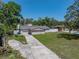 Aerial view of property showcasing a single story home with a long driveway and large front yard at 34477 Poinsettia Pl, Dade City, FL 33523