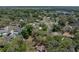 Lush aerial shot of a property surrounded by mature trees, enhanced by the presence of a calming lake at 34477 Poinsettia Pl, Dade City, FL 33523