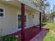 Cozy back porch with sturdy support beams and convenient access via double doors at 34477 Poinsettia Pl, Dade City, FL 33523