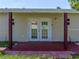 Charming covered back porch featuring double doors for easy access at 34477 Poinsettia Pl, Dade City, FL 33523