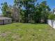 Green backyard with a fire pit area, ideal for outdoor gatherings and relaxation at 34477 Poinsettia Pl, Dade City, FL 33523