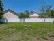 View of a large backyard featuring a built-in fire pit and privacy fence at 34477 Poinsettia Pl, Dade City, FL 33523