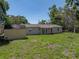 Large backyard with a storage shed, beautiful green grass, ideal for entertaining or relaxation at 34477 Poinsettia Pl, Dade City, FL 33523