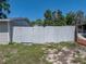 View of a white-painted wooden privacy fence enclosing the backyard at 34477 Poinsettia Pl, Dade City, FL 33523