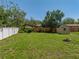 Picture of a grassy backyard with a fence and a shed at 34477 Poinsettia Pl, Dade City, FL 33523