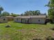 Spacious backyard with a fire pit, a shed, and a well-maintained lawn, perfect for outdoor activities at 34477 Poinsettia Pl, Dade City, FL 33523