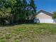 Large grassy backyard offering privacy and space at 34477 Poinsettia Pl, Dade City, FL 33523
