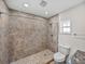 Modern bathroom featuring tiled walk-in shower, granite vanity, neutral colors and bright lighting at 34477 Poinsettia Pl, Dade City, FL 33523