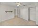 Bedroom featuring neutral walls, tile floors, a ceiling fan and a closet at 34477 Poinsettia Pl, Dade City, FL 33523