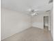 Bedroom featuring neutral walls, tiled floor and a ceiling fan at 34477 Poinsettia Pl, Dade City, FL 33523