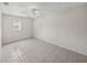 This bedroom has a tiled floor, ceiling fan and a sunny window at 34477 Poinsettia Pl, Dade City, FL 33523