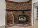 Close-up of a brick fireplace, showcasing its rustic charm and inviting atmosphere with wood storage at 34477 Poinsettia Pl, Dade City, FL 33523