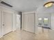 Hallway leading to doors and a large closet featuring neutral wall colors and tile flooring at 34477 Poinsettia Pl, Dade City, FL 33523