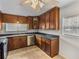 Stylish kitchen featuring dark wood cabinetry, stainless steel appliances, and ample storage space at 34477 Poinsettia Pl, Dade City, FL 33523