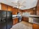 Functional kitchen with dark wood cabinets, stainless steel appliances, and neutral tile flooring at 34477 Poinsettia Pl, Dade City, FL 33523