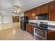 Open-concept view from kitchen, showcasing stainless steel appliances and connectivity to the living space at 34477 Poinsettia Pl, Dade City, FL 33523