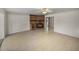 Large living room featuring a rustic brick fireplace, neutral tile flooring, and bright, open spaces at 34477 Poinsettia Pl, Dade City, FL 33523