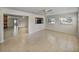 Open-concept living room with tile flooring, a kitchen view, and a cozy area with a fireplace at 34477 Poinsettia Pl, Dade City, FL 33523
