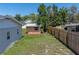 Backyard storage shed with a window and double doors, providing convenient outdoor storage at 34477 Poinsettia Pl, Dade City, FL 33523