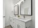 Modern bathroom featuring double vanity with marble countertops, large framed mirrors, and natural lighting at 3455 17Th S Ave, St Petersburg, FL 33711