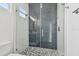 This bathroom features a sleek glass enclosed shower with a striking black and white mosaic tile floor at 3455 17Th S Ave, St Petersburg, FL 33711