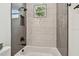 Featuring a bathtub with black shower head, and textured tile walls at 3455 17Th S Ave, St Petersburg, FL 33711
