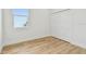 Bright bedroom featuring wood-look flooring, a window, and a closet for ample storage at 3455 17Th S Ave, St Petersburg, FL 33711