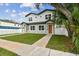 Charming two-story home with green grass, walkway and tidy landscaping on a sunny day at 3455 17Th S Ave, St Petersburg, FL 33711
