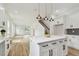 Kitchen with island, white cabinets, stainless steel appliances, and an open floor plan at 3455 17Th S Ave, St Petersburg, FL 33711