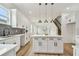 Modern kitchen featuring white cabinets, stainless steel appliances, a kitchen island, and an open floor plan at 3455 17Th S Ave, St Petersburg, FL 33711