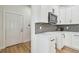 Stylish kitchen featuring white cabinets, stainless steel appliances, and modern backsplash at 3455 17Th S Ave, St Petersburg, FL 33711
