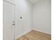 An empty room with white walls, a white door and wood-look flooring at 3455 17Th S Ave, St Petersburg, FL 33711