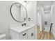 Bright bathroom featuring modern fixtures, a round mirror, and undermount sink at 3457 17Th S Ave, St Petersburg, FL 33711