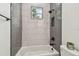 Well-lit bathroom featuring decorative accent wall tile, shower-tub combination, and modern hardware at 3457 17Th S Ave, St Petersburg, FL 33711