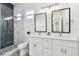 Modern bathroom boasts dual sinks, white cabinetry, and glass-enclosed shower at 3457 17Th S Ave, St Petersburg, FL 33711