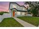 Charming two-story home featuring a well-manicured lawn and inviting entrance at 3457 17Th S Ave, St Petersburg, FL 33711