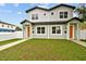 Inviting two-story home showcasing a lush green lawn and neatly aligned walkways at 3457 17Th S Ave, St Petersburg, FL 33711