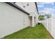 Exterior side view featuring a well-maintained lawn and neutral color palette at 3457 17Th S Ave, St Petersburg, FL 33711