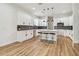 Well-appointed kitchen boasts a center island with bar stools, stainless steel appliances, and gray tile backsplash at 3457 17Th S Ave, St Petersburg, FL 33711