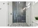 Modern glass shower with black and white tiles and mosaic floor detail at 3457 17Th S Ave, St Petersburg, FL 33711