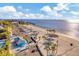 Aerial view of a beautiful community beach with a parking area and blue water at 3506 Seaway Dr, New Port Richey, FL 34652