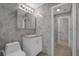 Bathroom featuring a toilet, white vanity with granite countertop, and a framed mirror with vanity lights at 3506 Seaway Dr, New Port Richey, FL 34652