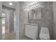 Bathroom with tile walls, walk-in shower, and single sink vanity at 3506 Seaway Dr, New Port Richey, FL 34652