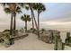 Secluded beach area with lush palms, ocean view, and peaceful seating at 3506 Seaway Dr, New Port Richey, FL 34652