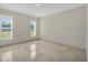 Spacious bedroom with tile floor and two windows providing natural light at 3506 Seaway Dr, New Port Richey, FL 34652